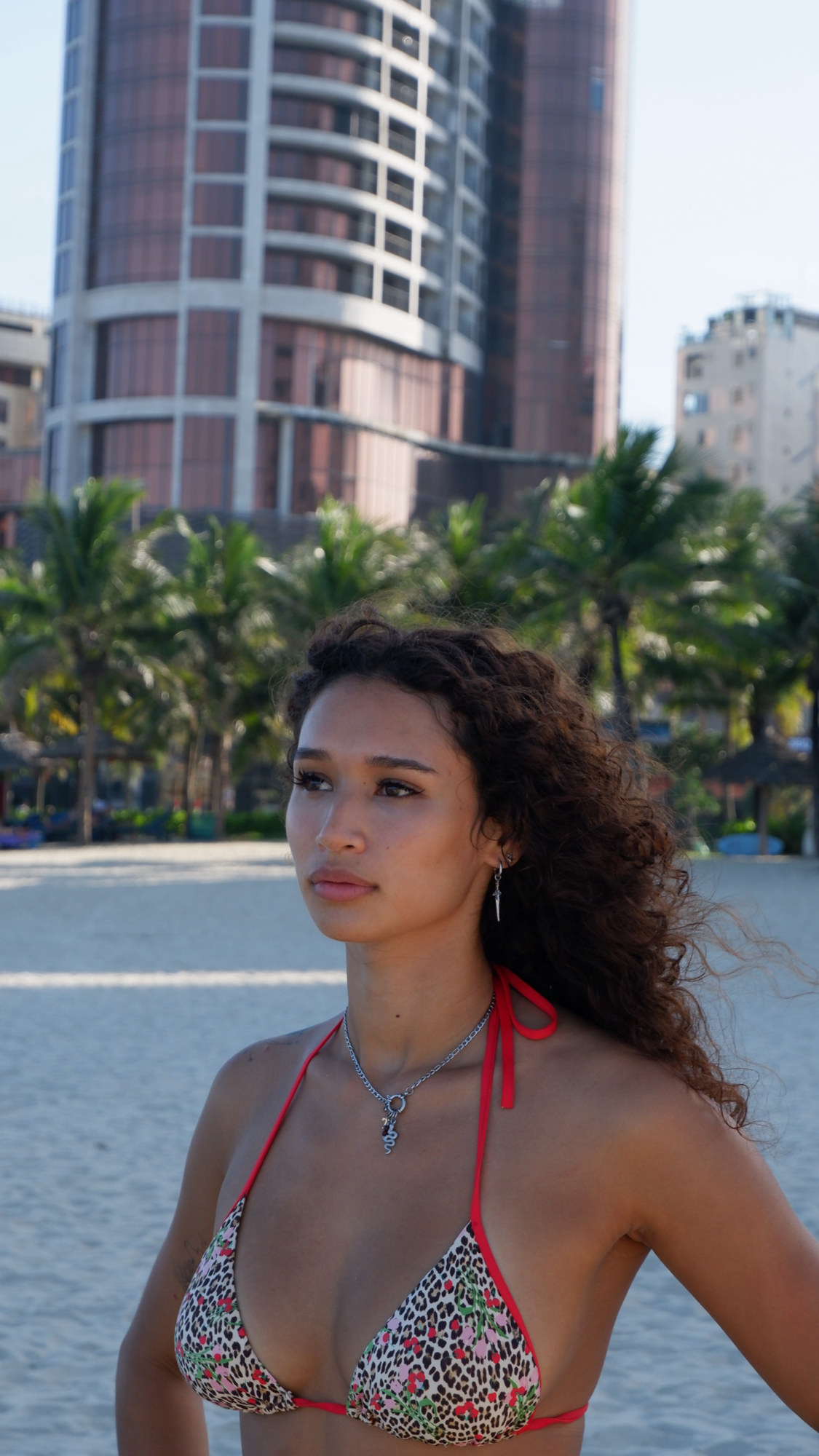 Thea on the beach, curly hair in the wind
