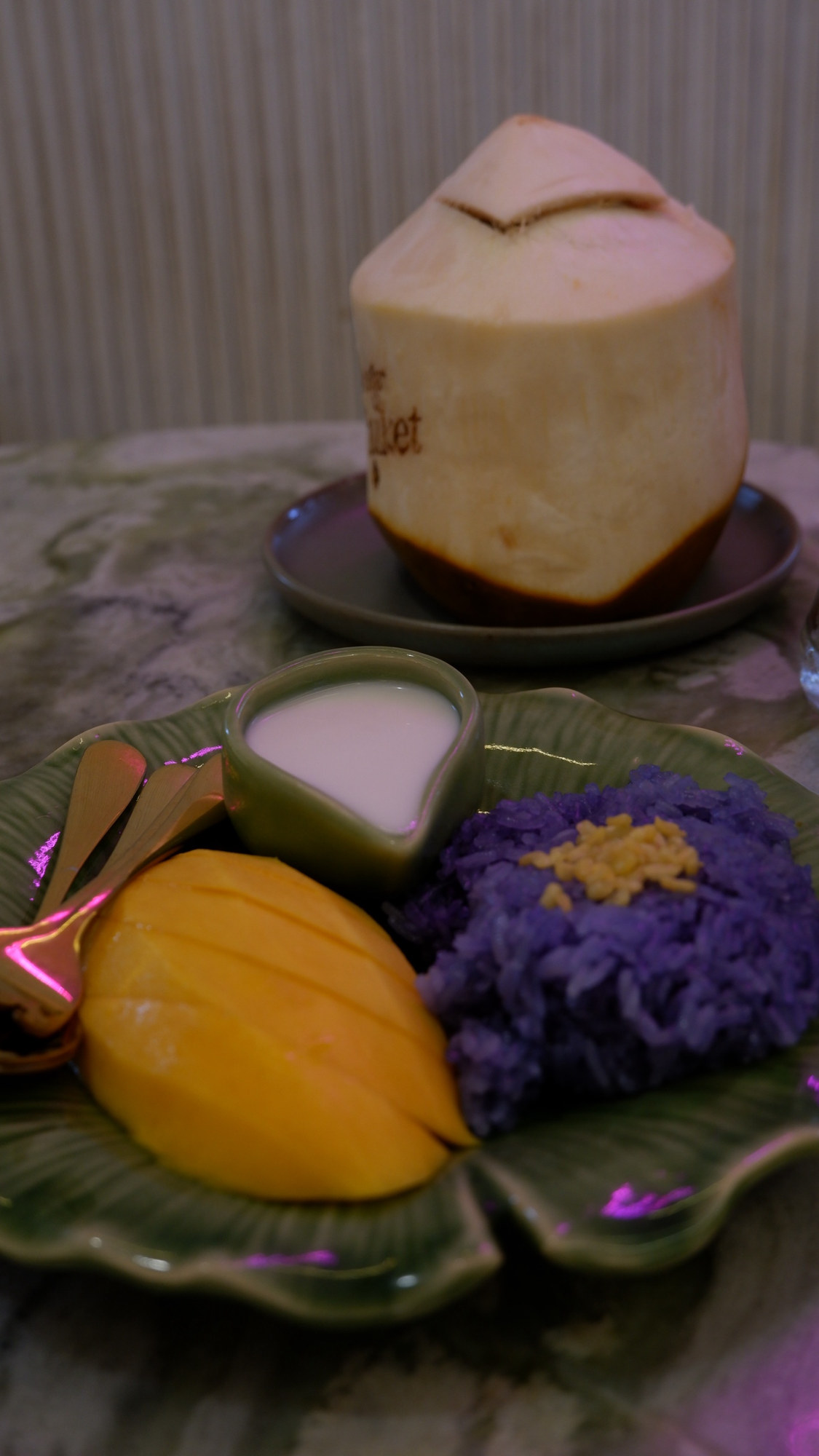 Mango sticky rice with butterfly-pea rice and a fresh coconut